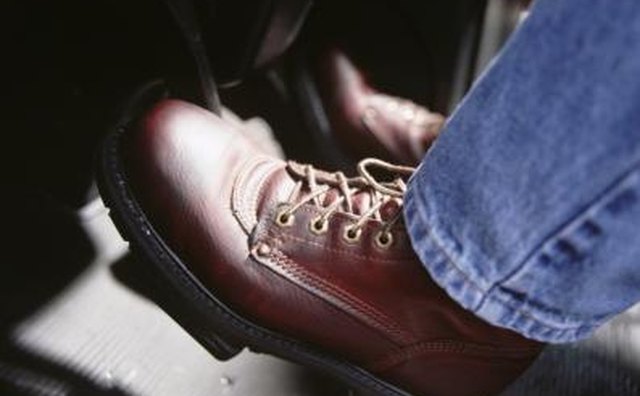 Foot on pedals in car.
