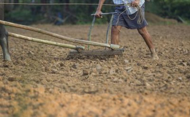 Man using a plow in his field