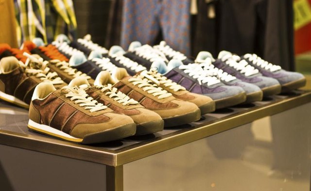 Mens athletic shoes on display in a clothing boutique.
