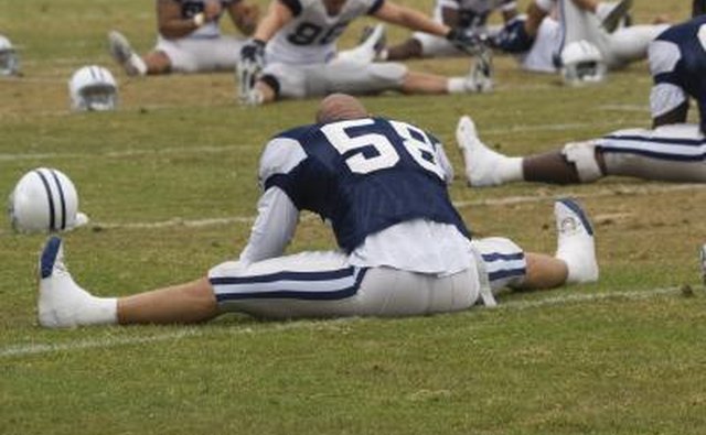 NFL football player stretching.