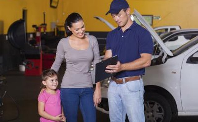 woman speaking with car mechanic