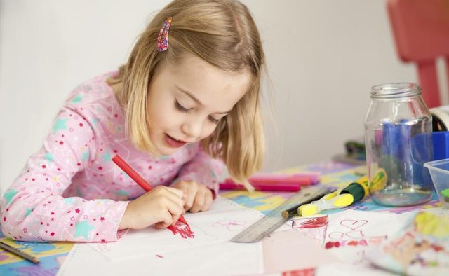 Little girl coloring on banner