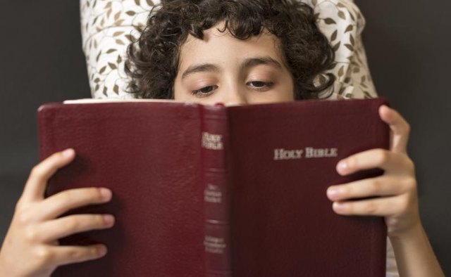 Child reading a bible