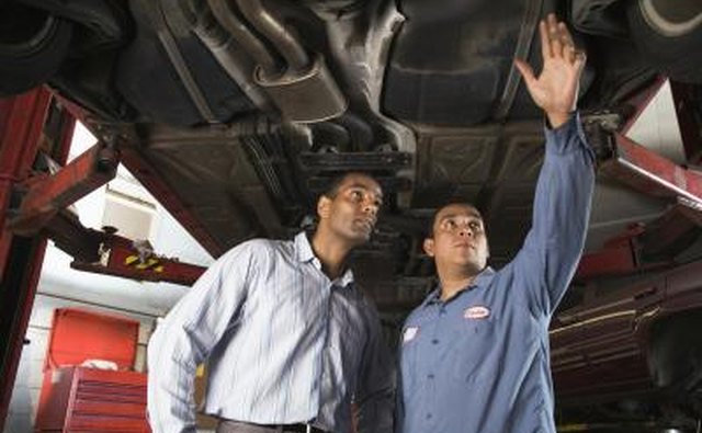 Mechanic showing car to customer