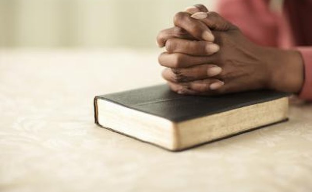 Woman praying with Bible