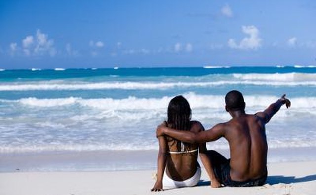 Dominican couple sitting at the beach