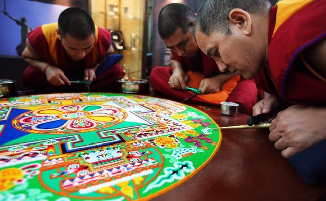 Tibetan monks completing a mandala