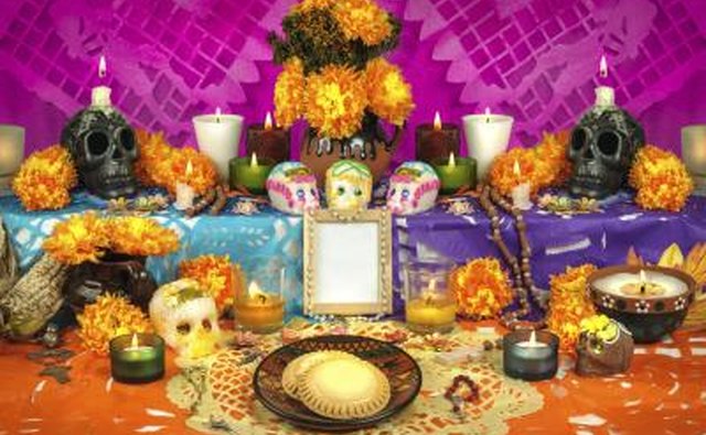 Day of the Dead altar with flowers, candles and skulls
