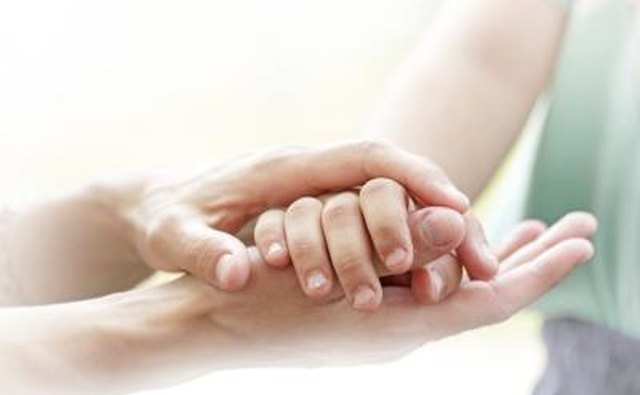 Parent and child holding hands.
