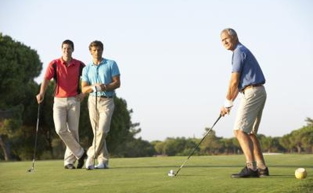 Three men on golf field