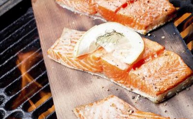Salmon being grilled on a cedar plank.