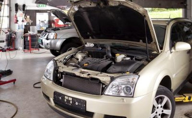 Attach the gauges to the service ports of the vehicle.