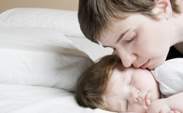 Teen mom kissing baby