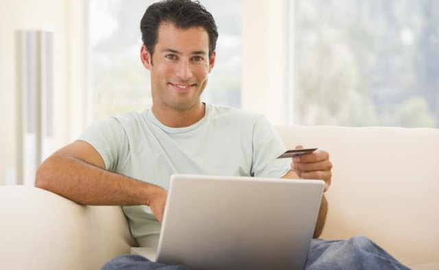 A man is shopping on his computer.