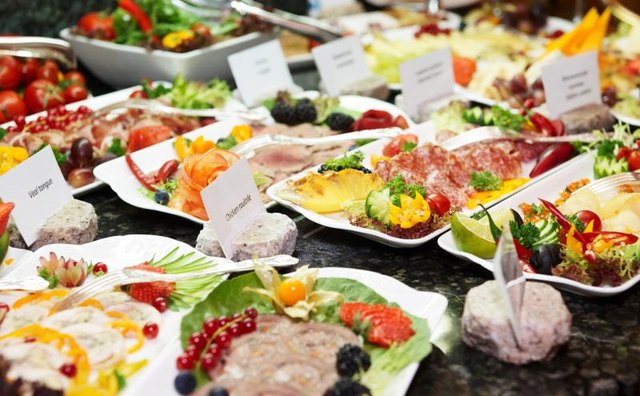 A full buffet with meat, cheese and fish