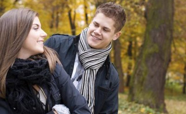 Boy looks at girl's scarf
