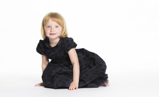 An appropriate dress for a young girl to wear to a funeral