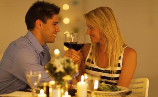 Couple toast wine at dinner table
