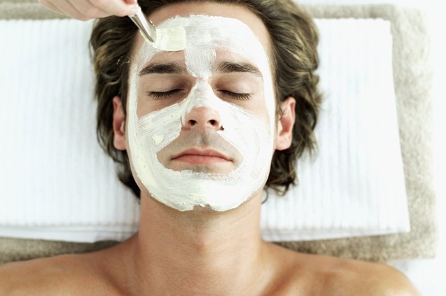 A young man receives a facial treatment.