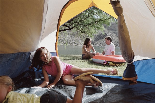 When it comes to family vacation options, pitching a tent can also mean pinching pennies.