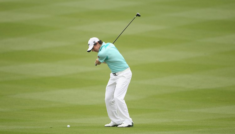 Both of McIlroy's knees are flexed and parallel to his target line as he comes down to hit the ball.