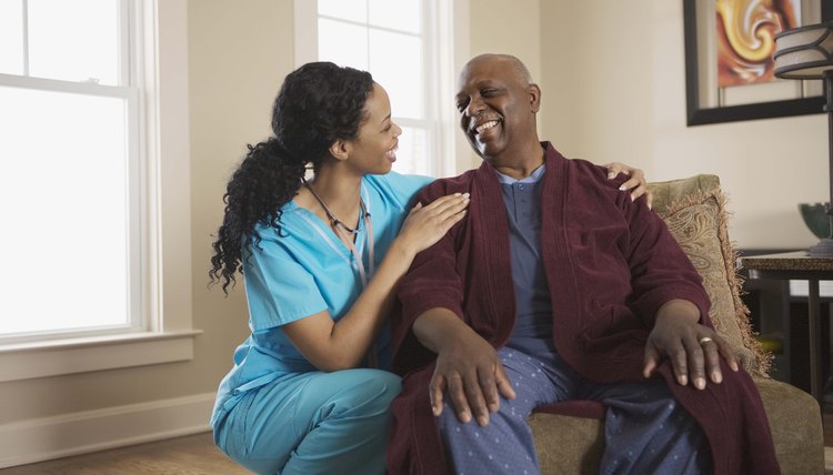 Nurse smiling with patient at home