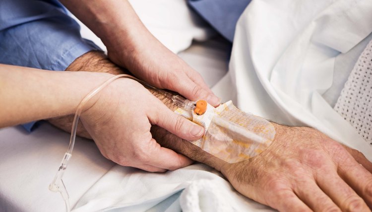 Nurse taping down intravenous device on patient