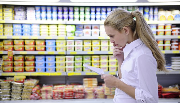 woman reading her shopping list in the supermarket