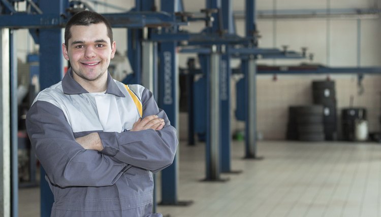Auto repair service. Handsome smiling mechanic.