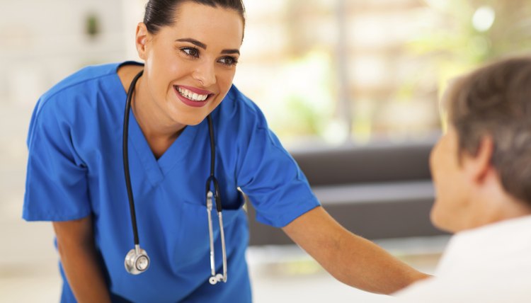 friendly young nurse talking to senior patient