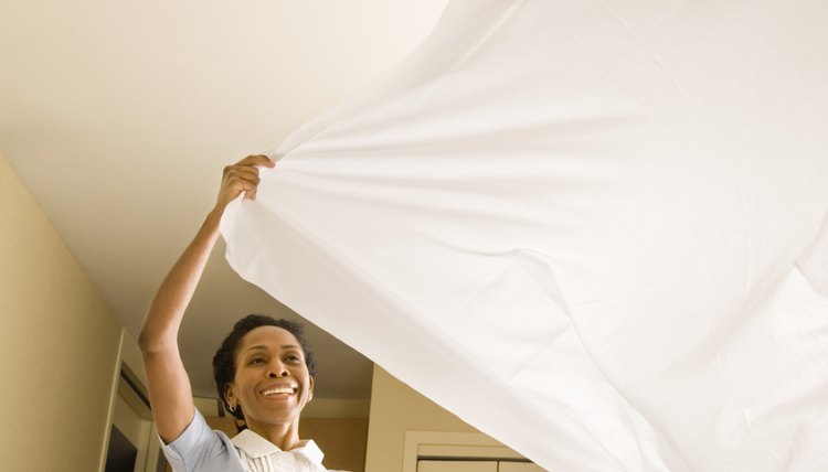 Maid making bed