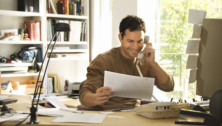 Man using telephone in home office