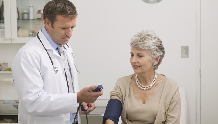 Doctor examining blood pressure of patient