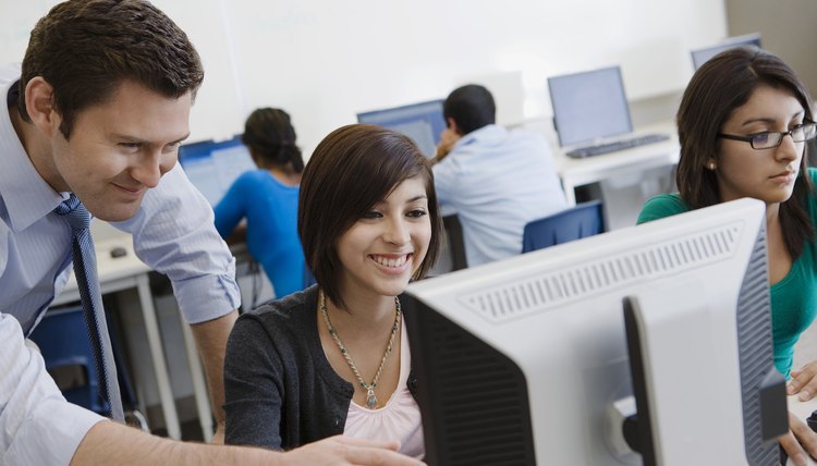 Teacher Helping Student in Computer Lab