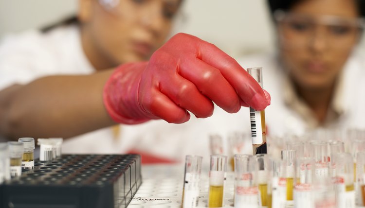 Hand with test tubes