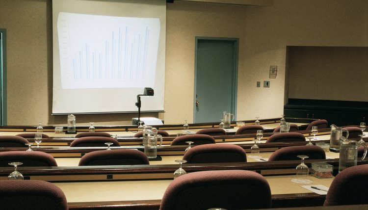 Empty seminar room with screen and overhead projector