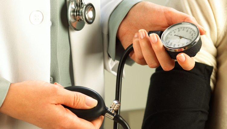 Taking blood pressure of patient
