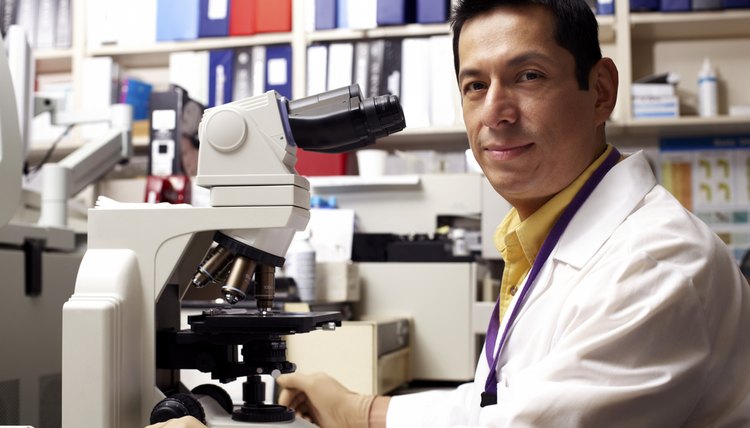 Healthcare worker using a microscope
