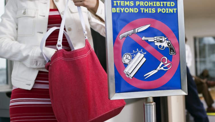 Woman by airport security sign