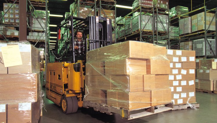 Forklift with boxes in warehouse