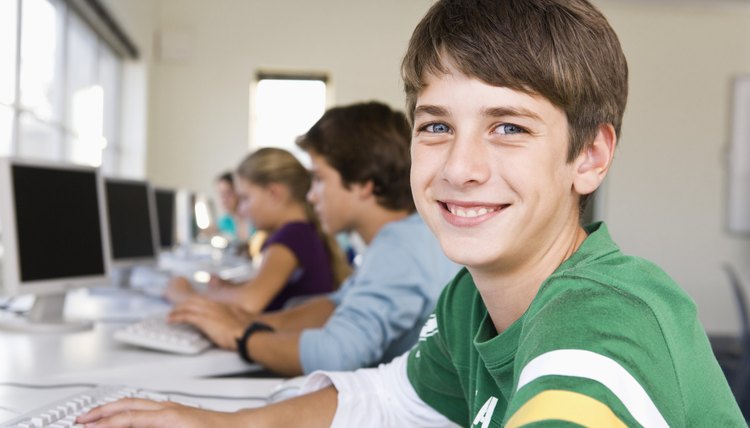 Portrait of student on computer in school