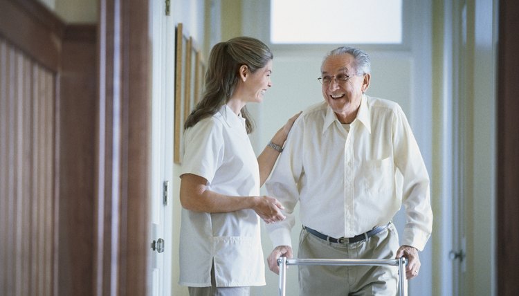 Nurse helping man with walker