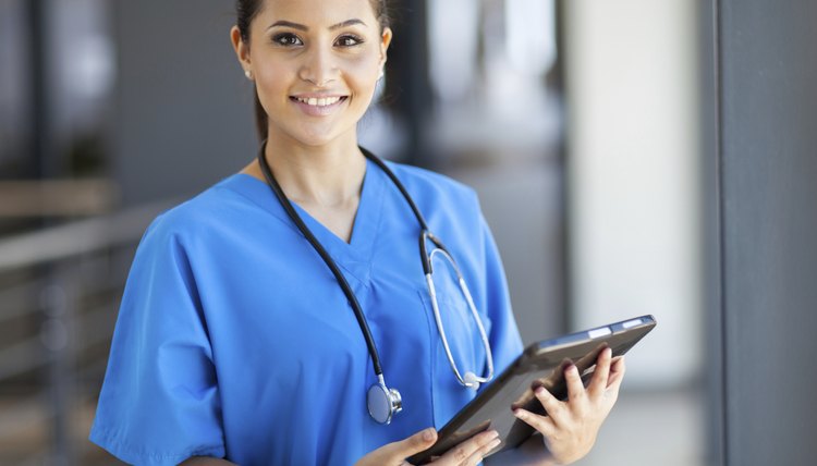 female medical intern with tablet computer