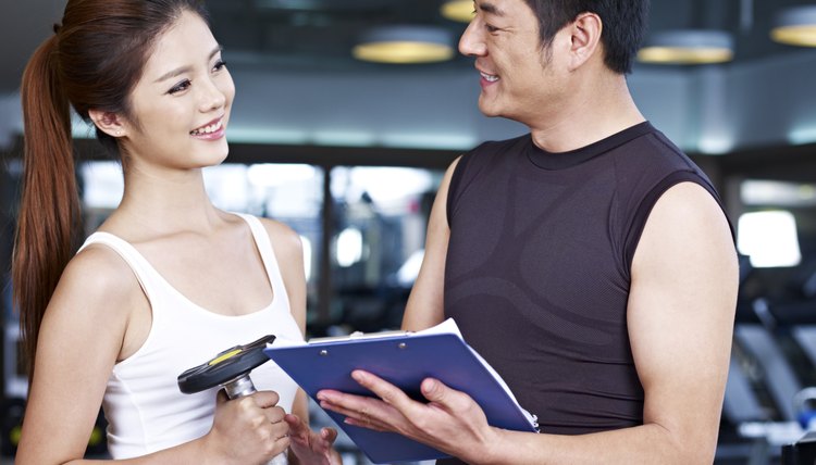 young man and woman talking in gym