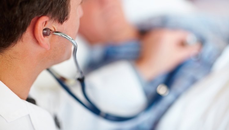 Doctor examining a patients heart beat with a stethoscope