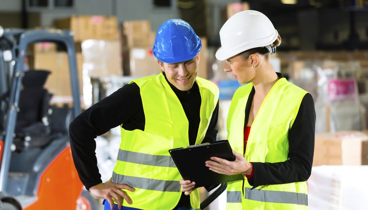 Forklift driver and supervisor at warehouse