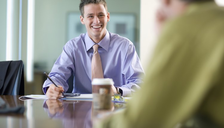 Young Businessman Smiling During Meeting