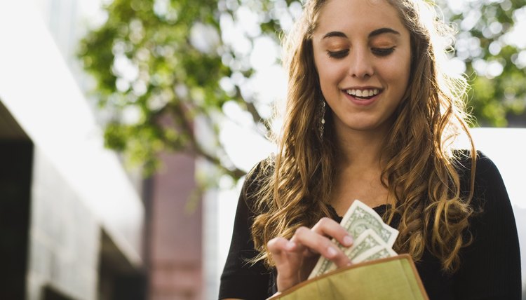 Teen removing money from wallet