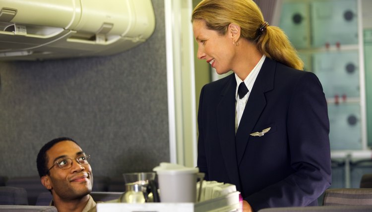 Flight attendant serving drinks