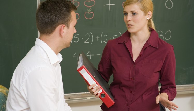 Teacher talking to man in class